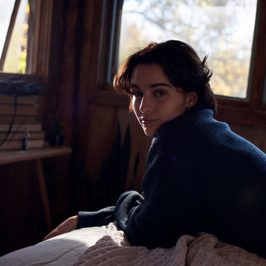brunette woman with short hair looking at camera